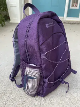 aerochamber2go fits in the side pocket of a purple backpack