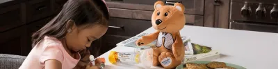 child with teddy bear and inhaler devices
