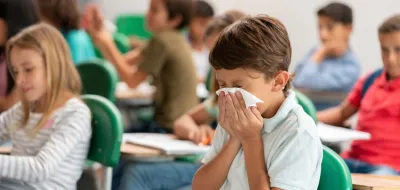 Child sneezing at school