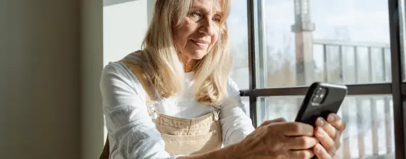 older woman holding smartphone