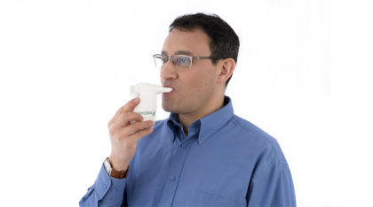 Aerobika OPEP Device in use by man, from the side 