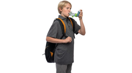 AeroChamber Plus Flow Vu Chamber green youth mouthpiece in use by boy