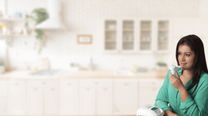 Young woman uses the nebulizer in a Kitchen