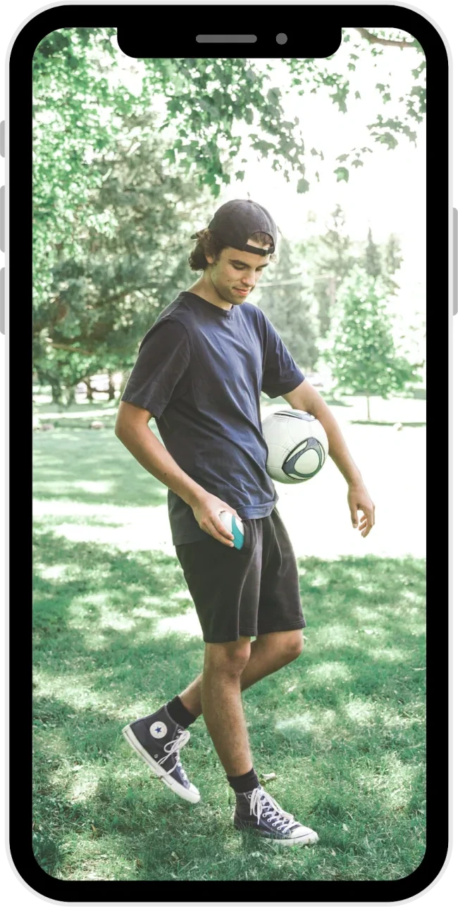 A young man carries his AeroChamber2Go* on his way to play soccer.
