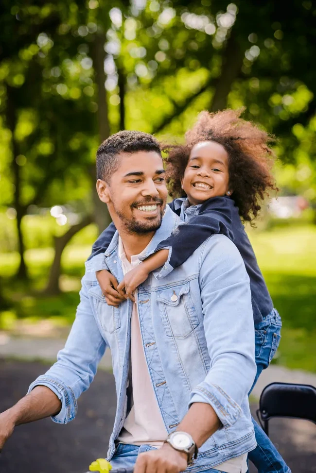 Man with daughter biking