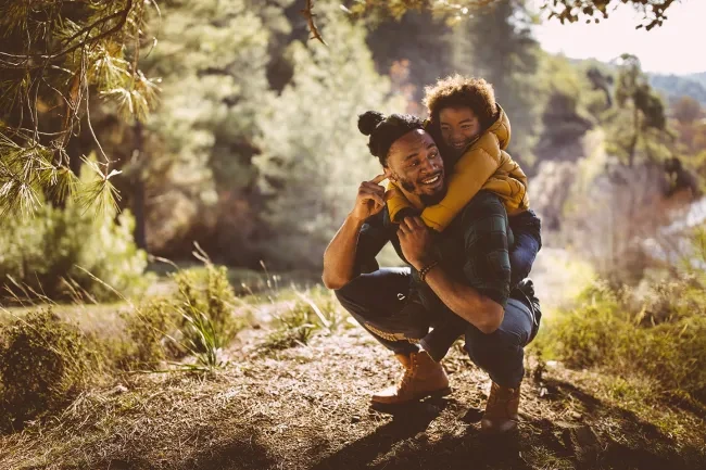 A father holding their child hero image