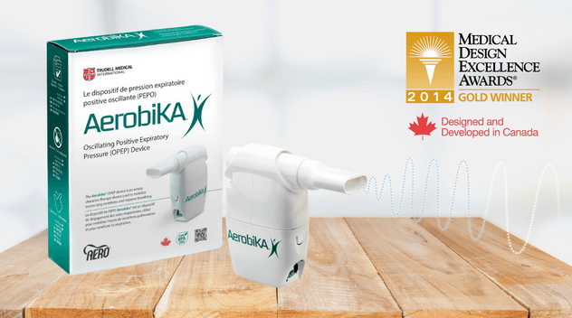 aerobika opep device on wooden table with icon for medical design excellence awards superimposed in top right corner