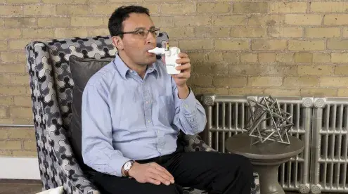 Aerobika OPEP Device in use by man, from the side